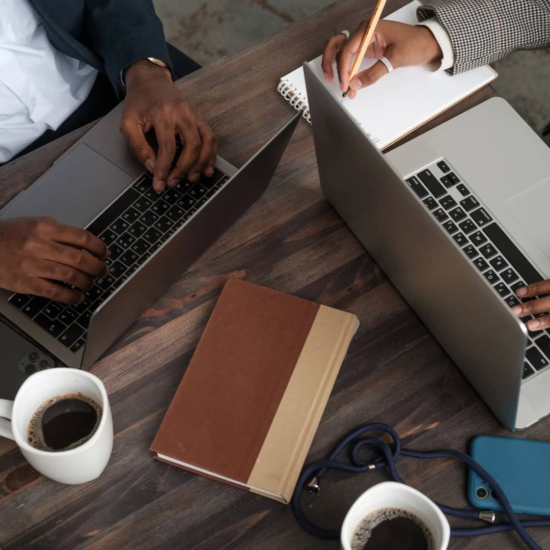 A vibrant Nigerian city street with various cars, motorcycles, and small businesses bustling with activity under a bright sunny sky